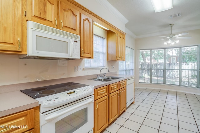 696 Aukai Pl, Diamondhead, MS 39525 - kitchen featuring white appliances, a sink, ornamental molding, light tile patterned floors, and light countertops