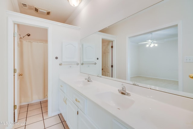 696 Aukai Pl, Diamondhead, MS 39525 - full bath with double vanity, tile patterned floors, a ceiling fan, and crown molding