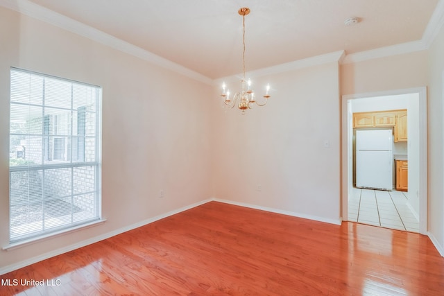 696 Aukai Pl, Diamondhead, MS 39525 - empty room with healthy amount of natural light, light wood-style flooring, a chandelier, ornamental molding, and baseboards