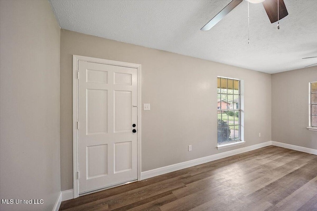 empty room with ceiling fan, a textured ceiling, and hardwood / wood-style floors