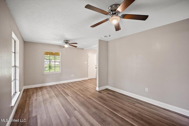 empty room with a textured ceiling, wood-type flooring, and ceiling fan