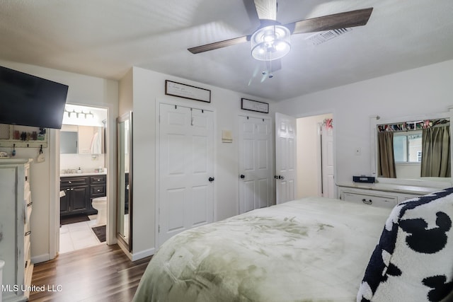 730 Holly Hills Dr, Biloxi, MS 39532 - bedroom featuring wood finished floors, ensuite bathroom, and a ceiling fan
