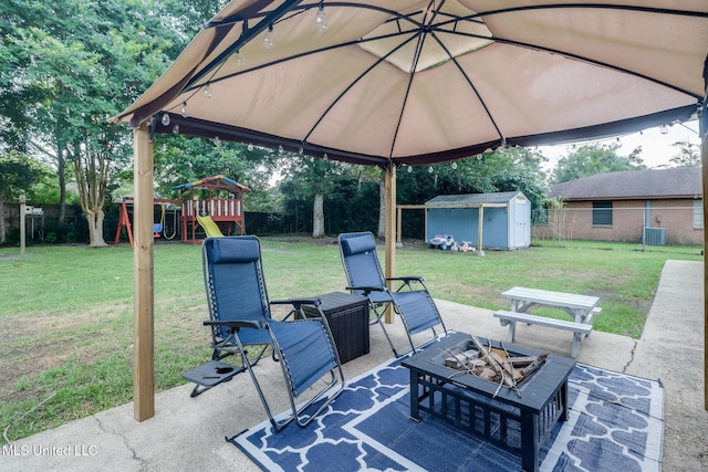 730 Holly Hills Dr, Biloxi, MS 39532 - fenced backyard with a patio area, an outdoor fire pit, a storage unit, and a playground