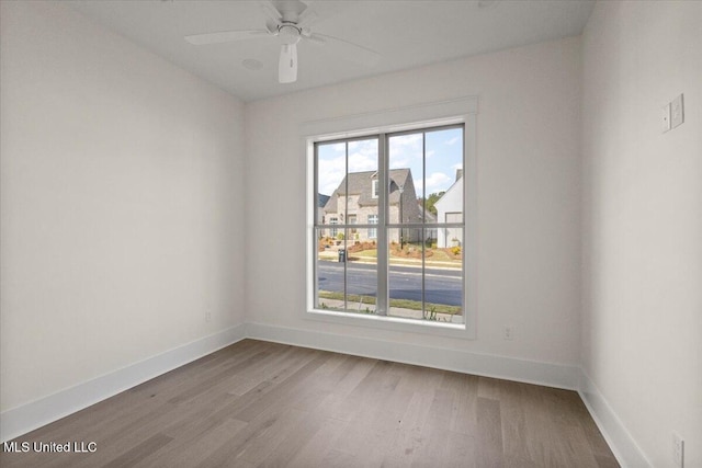 113 Water St, Madison, MS 39110 - empty room featuring wood finished floors, baseboards, and a ceiling fan