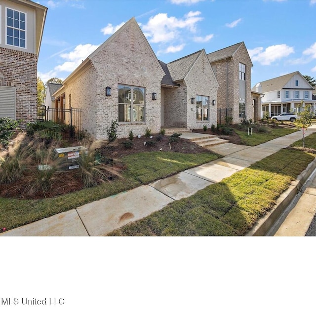 113 Water St, Madison, MS 39110 - view of front of property with brick siding and a front lawn
