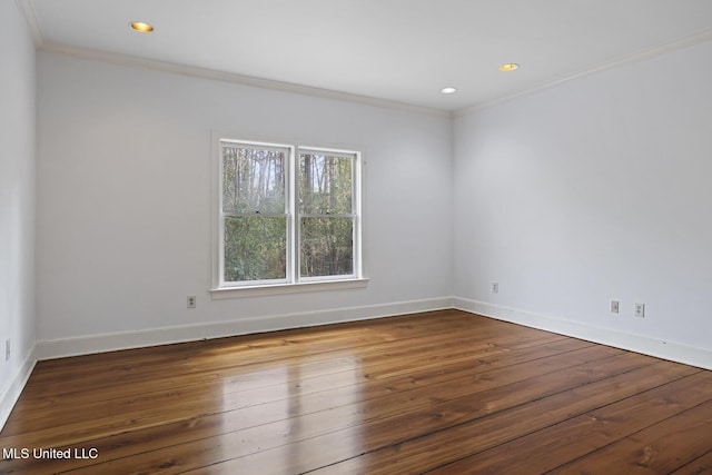 unfurnished room with ornamental molding and hardwood / wood-style floors