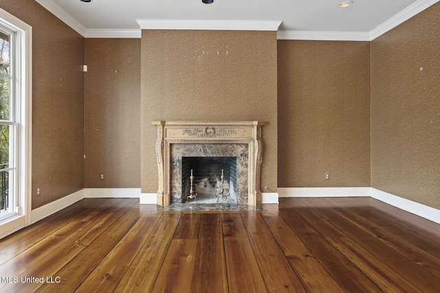 unfurnished living room with a fireplace, ornamental molding, and wood-type flooring