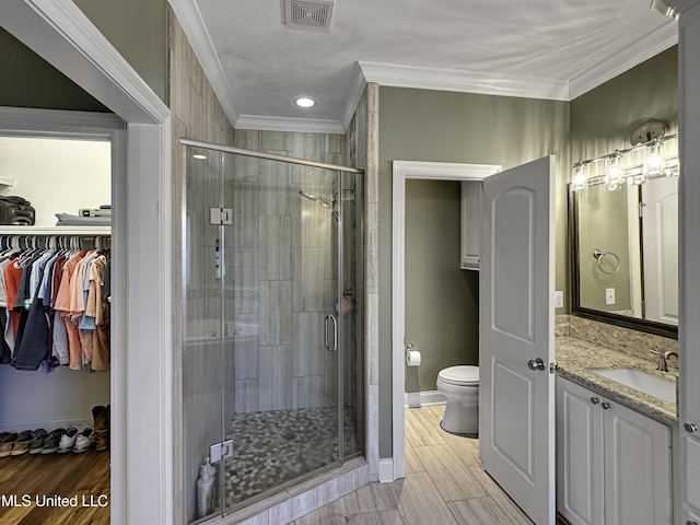 214 Terrapin Creek Rd, Brandon, MS 39042 - full bathroom featuring ornamental molding, toilet, vanity, a shower stall, and a spacious closet