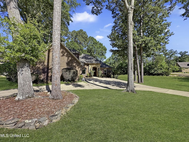 214 Terrapin Creek Rd, Brandon, MS 39042 - view of front of property featuring curved driveway, a front lawn, and brick siding