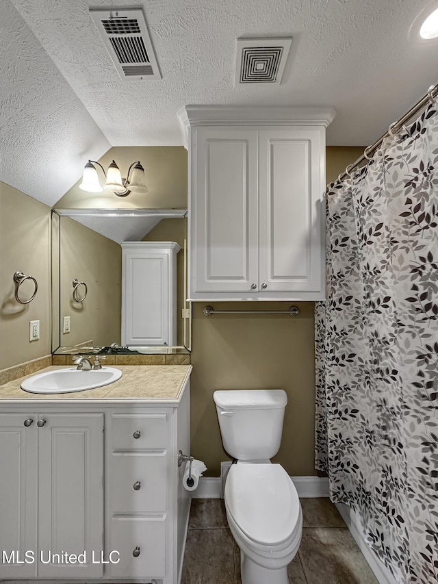 214 Terrapin Creek Rd, Brandon, MS 39042 - full bath featuring toilet, vanity, a textured ceiling, vaulted ceiling, and tile patterned floors