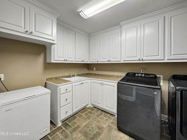 214 Terrapin Creek Rd, Brandon, MS 39042 - washroom with washing machine and clothes dryer, cabinet space, and brick patterned floors