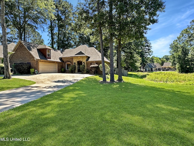 214 Terrapin Creek Rd, Brandon, MS 39042 - french provincial home featuring driveway, brick siding, a front yard, a shingled roof, and an attached garage
