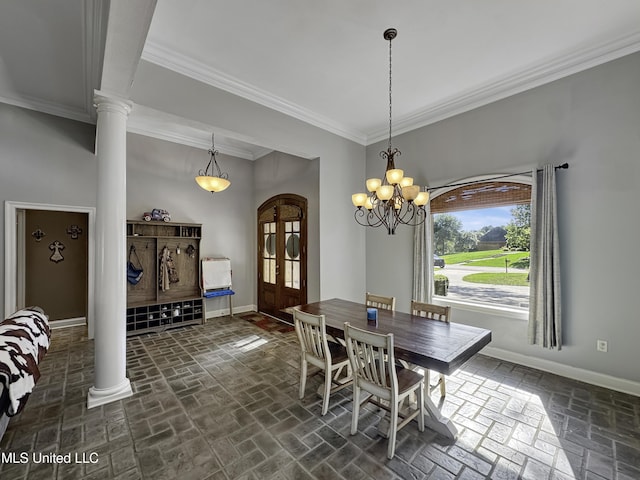 214 Terrapin Creek Rd, Brandon, MS 39042 - dining space featuring baseboards, brick floors, crown molding, ornate columns, and a chandelier