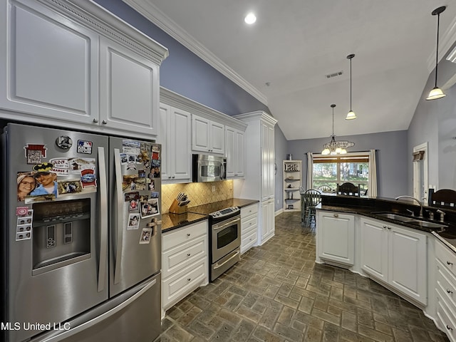 214 Terrapin Creek Rd, Brandon, MS 39042 - kitchen with appliances with stainless steel finishes, a chandelier, vaulted ceiling, a sink, and brick patterned floors