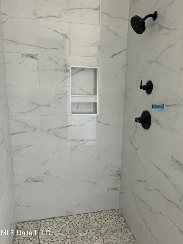 bathroom with a tile shower