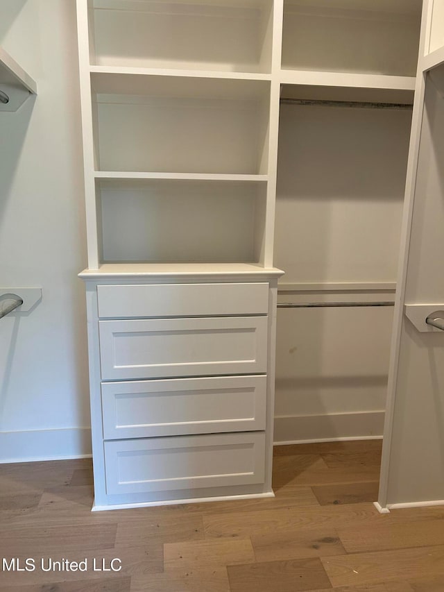 walk in closet featuring light hardwood / wood-style flooring