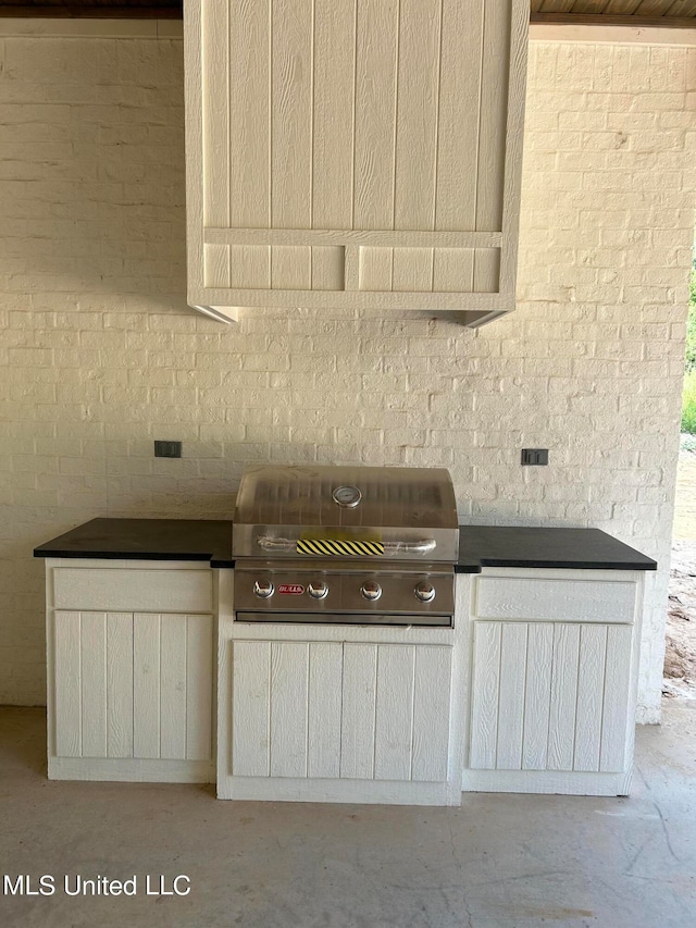 kitchen featuring brick wall