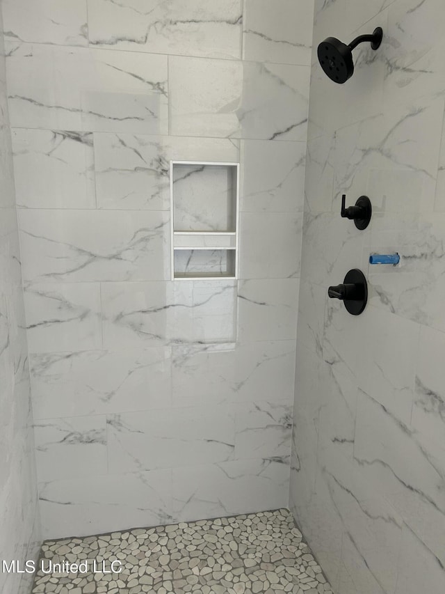 bathroom with tiled shower