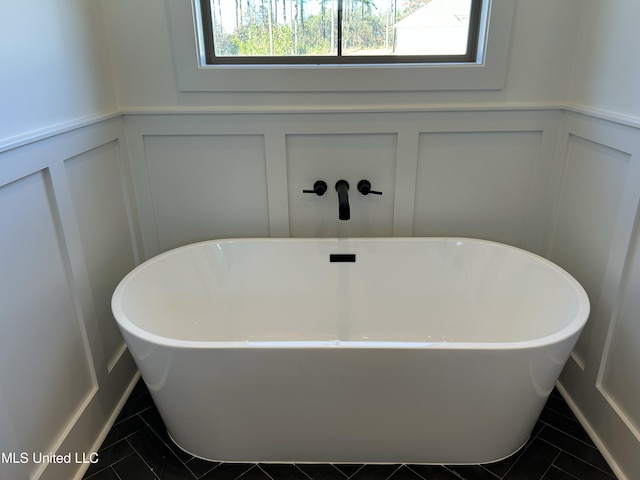 bathroom featuring tile patterned floors and a bathtub