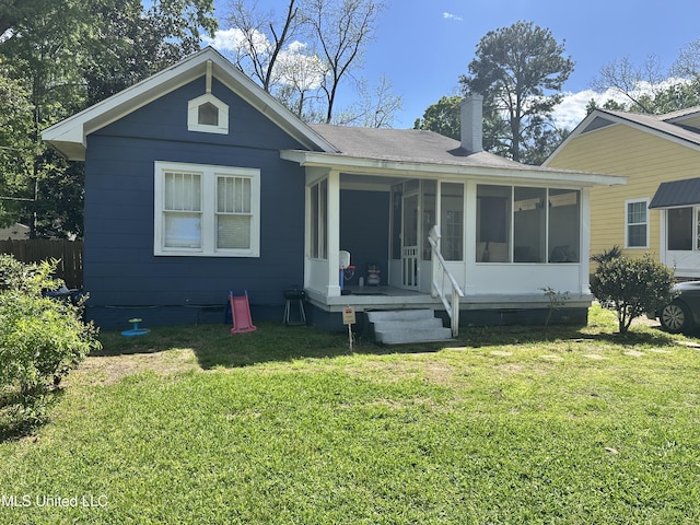 425 Downing St, Jackson, MS 39216 - view of front facade featuring crawl space, a chimney, a front yard, a sunroom, and roof with shingles