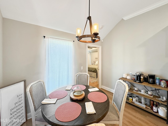 708 Silver Bnd, Pearl, MS 39208 - dining area with a chandelier, light wood-type flooring, vaulted ceiling, and ornamental molding
