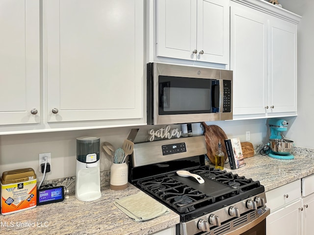 708 Silver Bnd, Pearl, MS 39208 - kitchen featuring stainless steel appliances, white cabinetry, and light stone counters