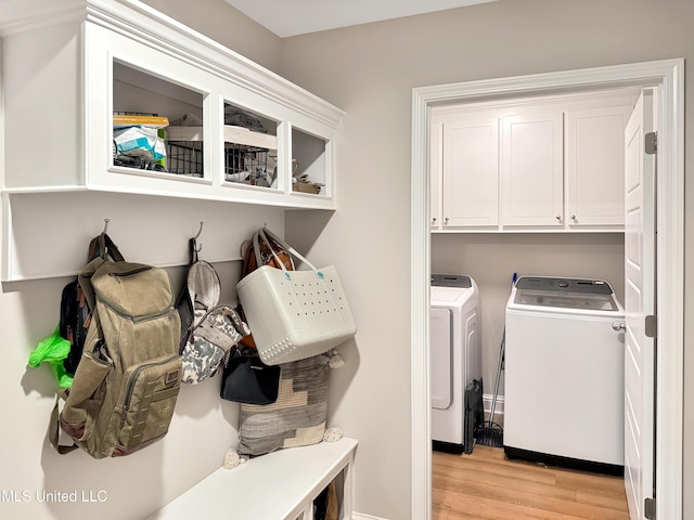 708 Silver Bnd, Pearl, MS 39208 - washroom featuring washer and clothes dryer, light wood finished floors, and cabinet space