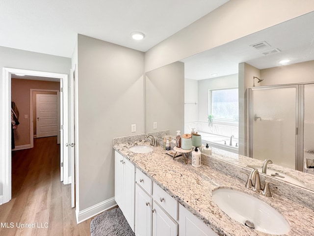 708 Silver Bnd, Pearl, MS 39208 - full bath with double vanity, a shower stall, wood finished floors, and a bath