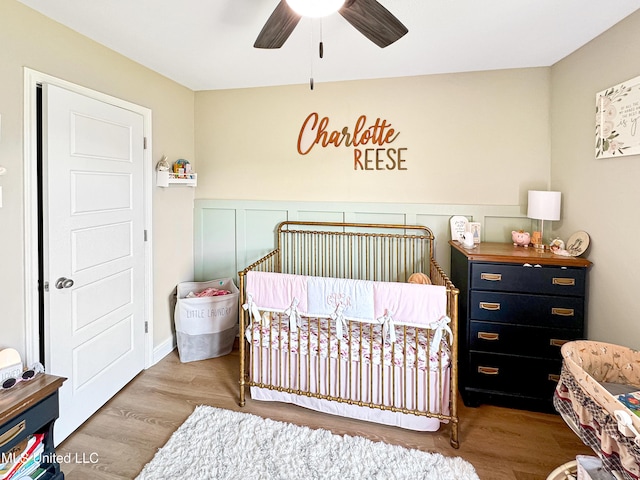 708 Silver Bnd, Pearl, MS 39208 - bedroom with a crib, wood finished floors, and a ceiling fan