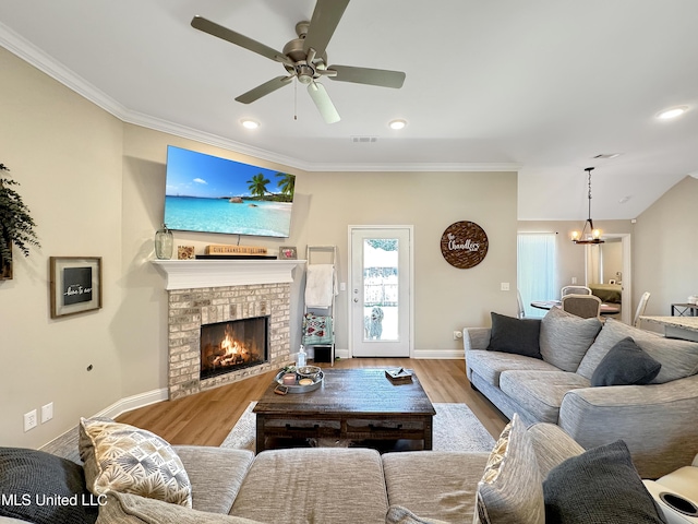 708 Silver Bnd, Pearl, MS 39208 - living area featuring wood finished floors, a ceiling fan, a brick fireplace, a chandelier, and crown molding