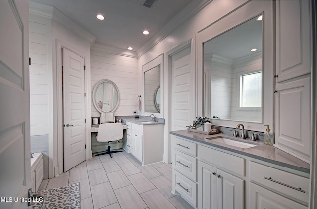full bath with crown molding, two vanities, recessed lighting, tile patterned flooring, and a bathtub