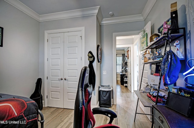 bedroom featuring ornamental molding, wood finished floors, and a closet