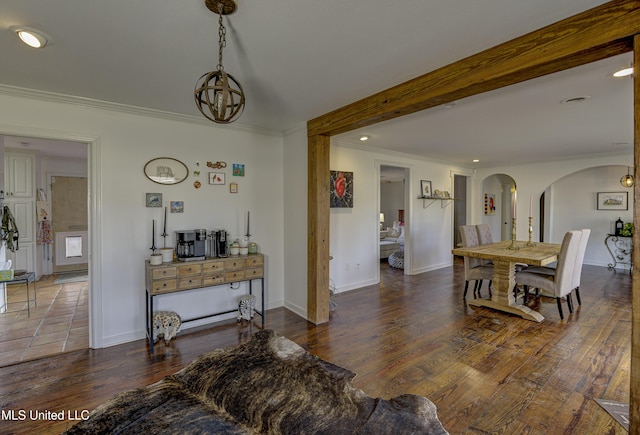 living room featuring crown molding, dark hardwood / wood-style floors, a notable chandelier, and beam ceiling