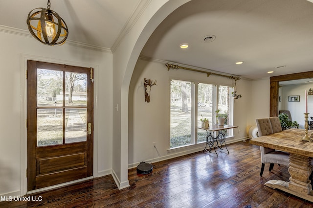 foyer entrance featuring ornamental molding and dark hardwood / wood-style floors