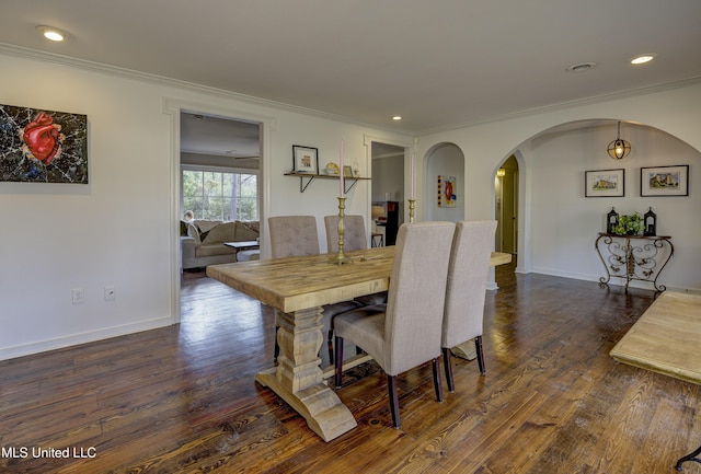 dining area featuring ornamental molding and dark hardwood / wood-style floors