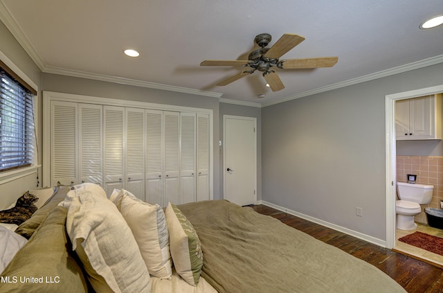 bedroom with crown molding, dark wood-type flooring, a closet, and ensuite bathroom