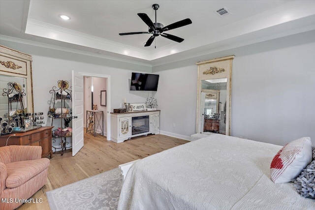 221 Lost Oak Ln, Brandon, MS 39047 - bedroom with a tray ceiling, light wood-style flooring, crown molding, recessed lighting, and ensuite bathroom