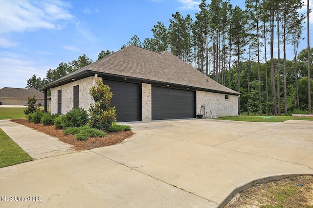 221 Lost Oak Ln, Brandon, MS 39047 - view of home's exterior featuring driveway, brick siding, a garage, and a yard