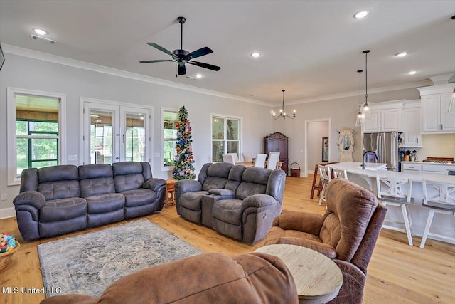 221 Lost Oak Ln, Brandon, MS 39047 - living area with plenty of natural light, a ceiling fan, a chandelier, light wood finished floors, and crown molding