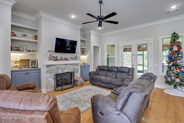221 Lost Oak Ln, Brandon, MS 39047 - living area featuring ceiling fan, french doors, crown molding, wood finished floors, and a fireplace