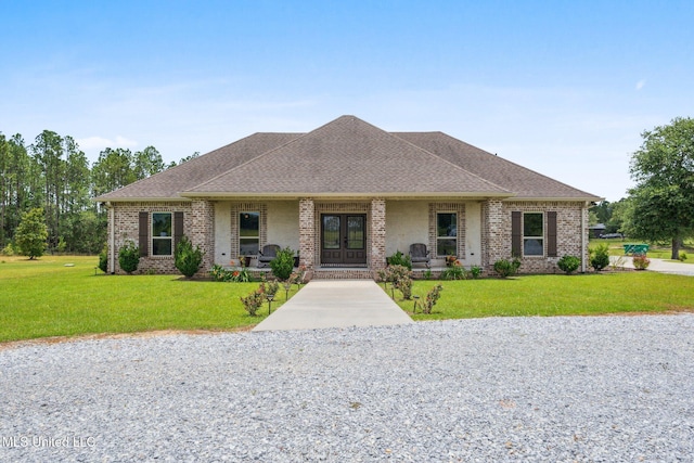 22105 Rd 357, Kiln, MS 39556 - view of front of house with french doors, a front lawn, brick siding, and roof with shingles