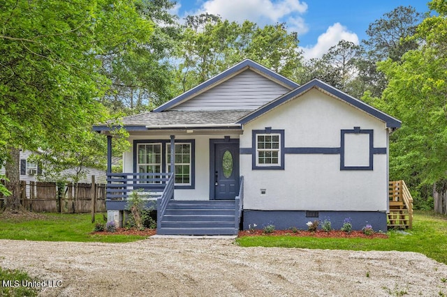 bungalow-style house featuring crawl space, roof with shingles, covered porch, and fence