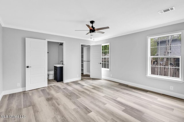 unfurnished bedroom featuring visible vents, baseboards, crown molding, and wood finished floors