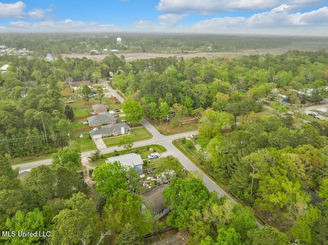 birds eye view of property featuring a view of trees