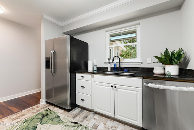 3106 Breezy Hill Ln, Ocean Springs, MS 39564 - kitchen with appliances with stainless steel finishes, crown molding, white cabinets, light wood-style floors, and dark stone countertops