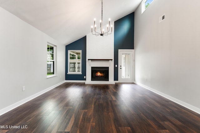 3106 Breezy Hill Ln, Ocean Springs, MS 39564 - unfurnished living room featuring a chandelier, a brick fireplace, high vaulted ceiling, and dark wood finished floors