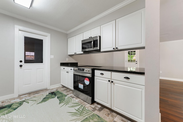 3106 Breezy Hill Ln, Ocean Springs, MS 39564 - kitchen featuring appliances with stainless steel finishes, white cabinetry, dark countertops, and crown molding