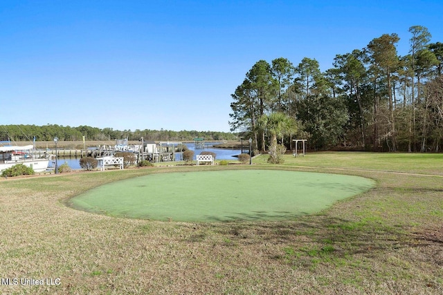 surrounding community featuring a yard and a water view