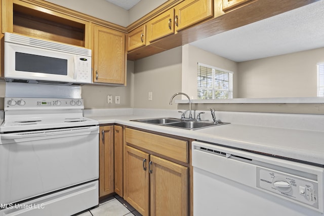 kitchen featuring a sink, a textured ceiling, white appliances, light tile patterned flooring, and light countertops