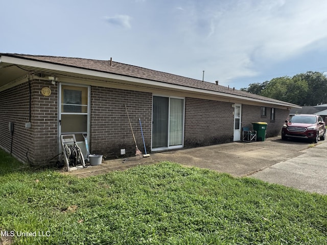 15708 Orleans Dr, Biloxi, MS 39532 - rear view of house featuring brick siding and a lawn